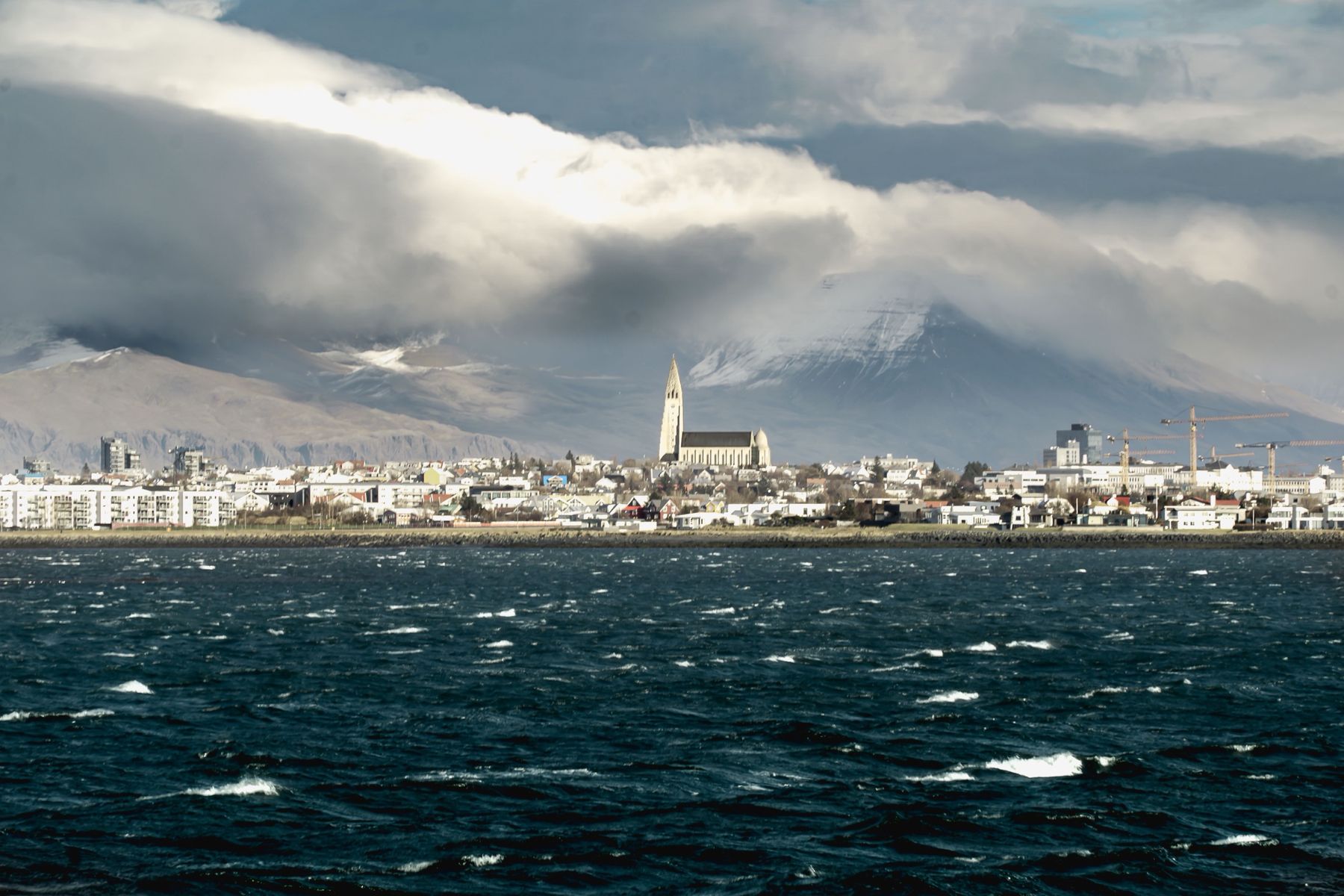 Reykjavík and Hallgrímskirkja church seen across the bay under heavy cloud